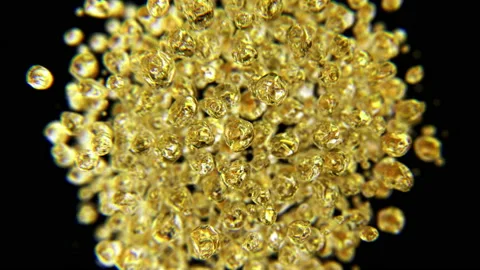 Golden drops jumping in slow motion 4K Stock Footage 149607451