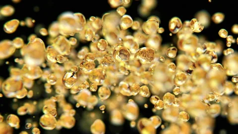 Golden drops jumping in slow motion 4K Stock Footage 149649879