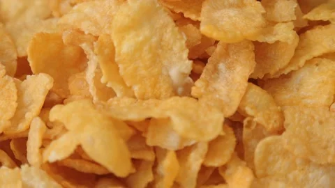 Golden dry cornflakes super close up slowly rotating stock footage Stock Footage 142663480