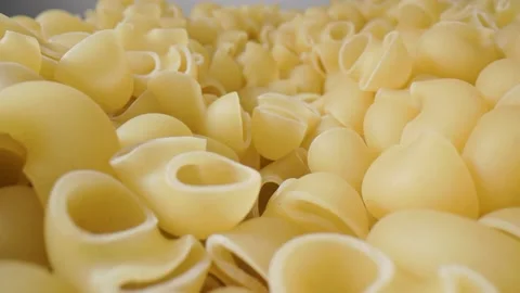 Golden dry pasta extremely close-up in macro mode linear movement. Stock Footage 211399312
