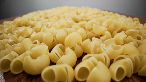 Golden dry pasta extremely close-up in macro mode linear movement. Stock Footage 211399319