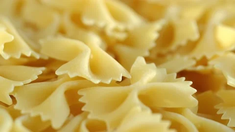 Golden dry pasta extremely close-up in macro mode. Rotation 4K Stock Footage 231379588