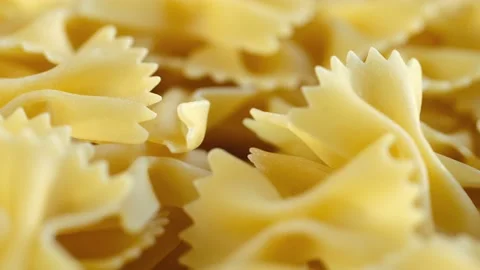 Golden dry pasta extremely close-up in macro mode. Rotation 4K Stock Footage 231544190