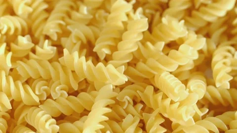 Golden dry pasta extremely close-up in macro mode. Rotation 4K Stock Footage 231544307