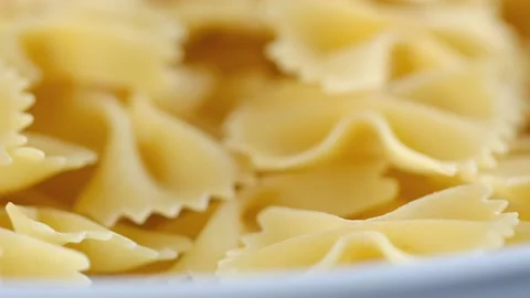 Golden dry pasta extremely close-up in macro mode. Rotation 4K Stock Footage 231872535