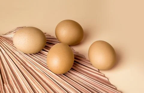 Golden dyed Easter eggs on beige background. Celebration of religious holiday Stock Photos