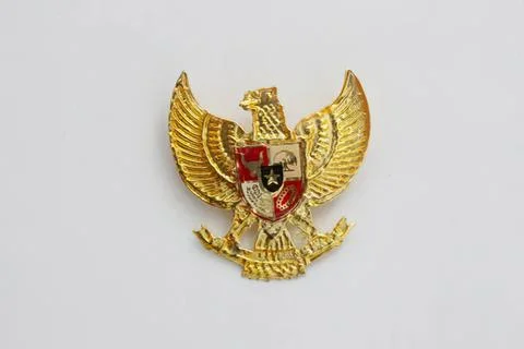 Golden eagle badge with shield emblem on plain background Stock Photos