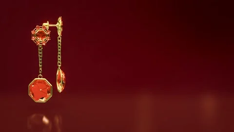 Golden eardrops with red ruby jewels rotate on bright bg, fictive Stock Footage 201030614