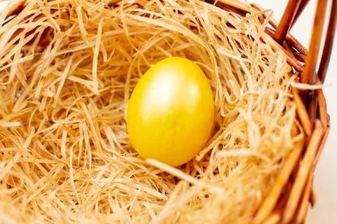 Golden easter egg in a basket Stock Photos