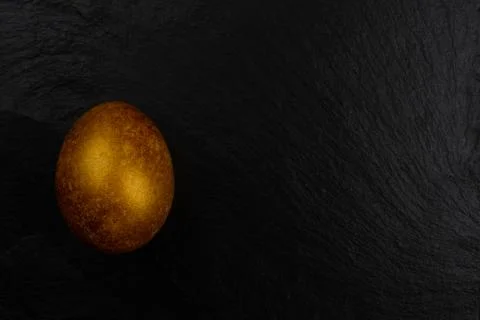 Golden easter egg on black Stock Photos