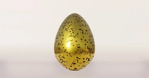 Golden Easter egg with black terrazzo pattern rotates on beige background Stock Footage 151107188