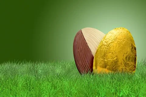 Golden Easter egg on grass on green background Stock Photos