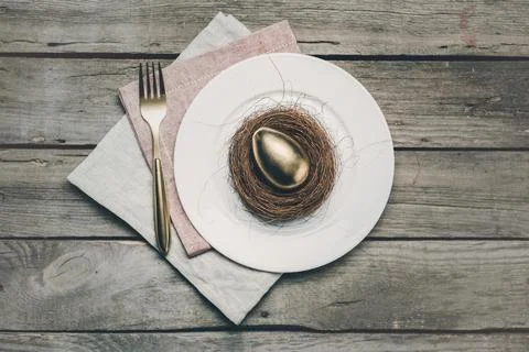 Golden easter egg on plate Stock Photos