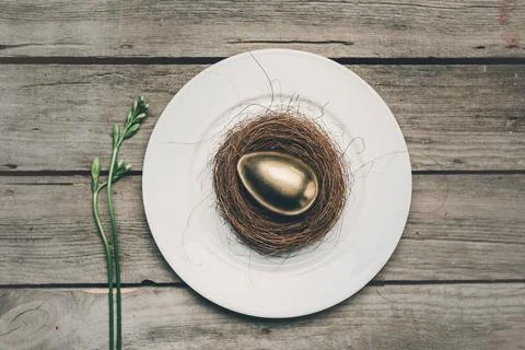 Golden easter egg on plate Stock Photos