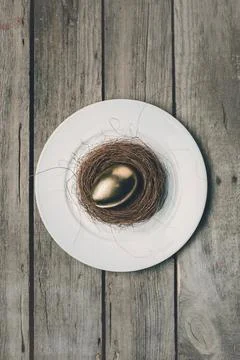 Golden easter egg on plate Stock Photos