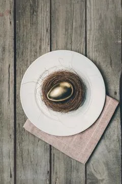 Golden easter egg on plate Stock Photos