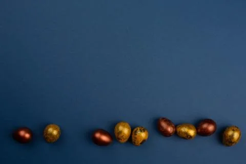 Golden easter eggs on blue Stock Photos