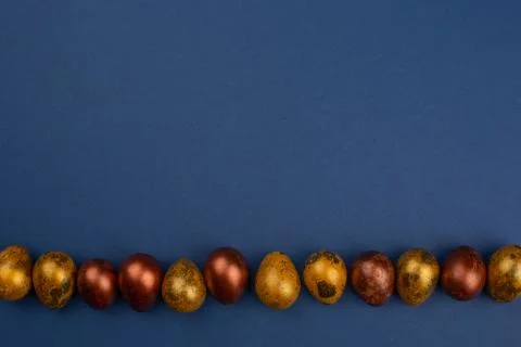 Golden easter eggs on blue Stock Photos