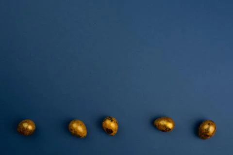 Golden easter eggs on blue Stock Photos