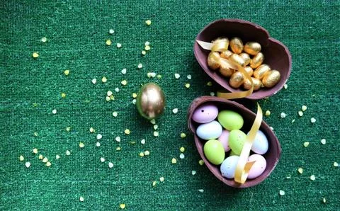 Golden Easter eggs on a green background Stock Photos