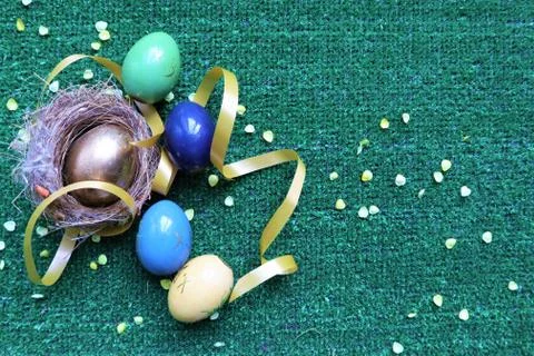 Golden Easter eggs on a green background Stock Photos