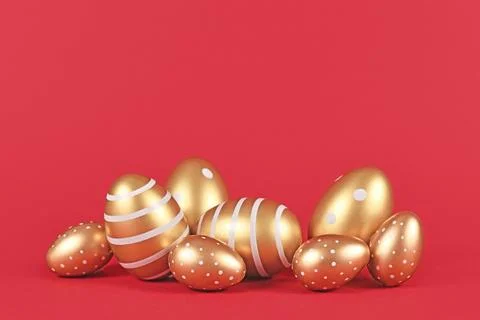Golden Easter eggs with simple stripe and dot pattern on red background with 스톡 사진