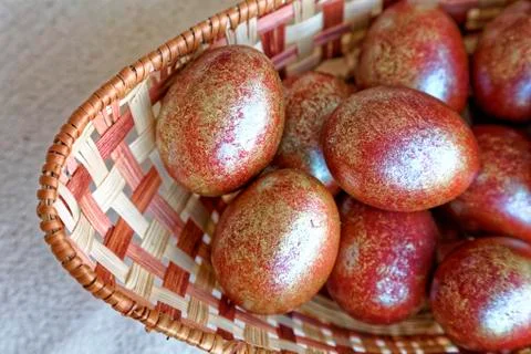Golden Easter eggs in a wicker basket. Holiday food. Stock Photos