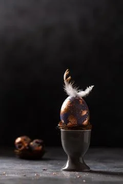 Golden egg. Easter gold egg wth feather above. Easter egg decoration with pat Stock Photos