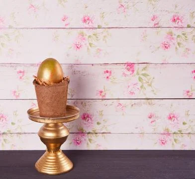 Golden egg in a pots on the table Stock Photos