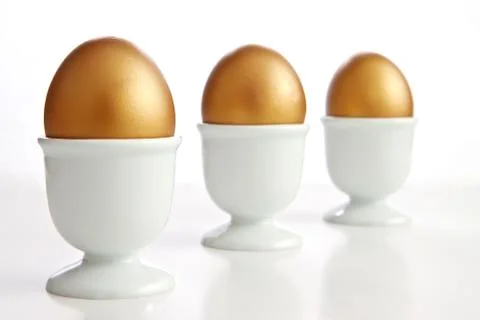 Golden egg on a white background Stock Photos