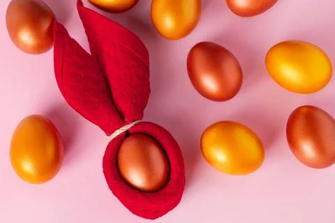 Golden eggs and Easter bunny on a pink background. Happy holiday. Stock Photos