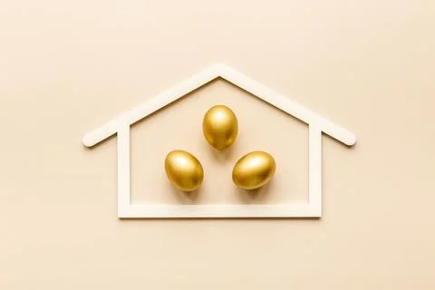 Golden eggs flat lay. Save money. Wealth and good luck symbol Stock Photos