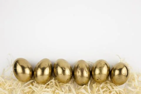 Golden eggs straw Stock Photos