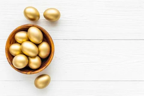 Golden eggs in wooden bowl. Wealth and good luck concept. Easter decoration Stock Photos
