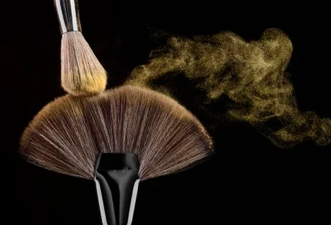 Golden elements' floating from brush Stock Photos