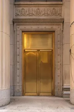 Golden elevator door set in elegant marble building Stock-Fotos