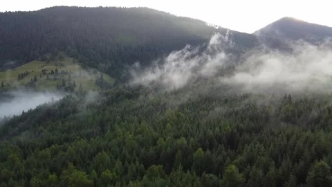 Golden evening light over mountain valley and drifting clouds Stock Footage 338104604