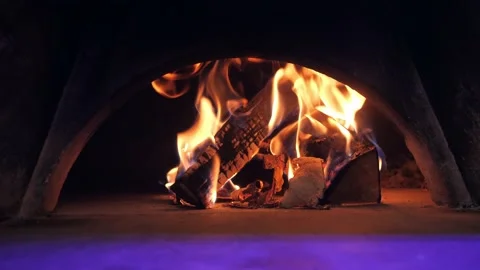 Golden fire flame covers chopped firewood pile heating stove Stock-Footage 133077347