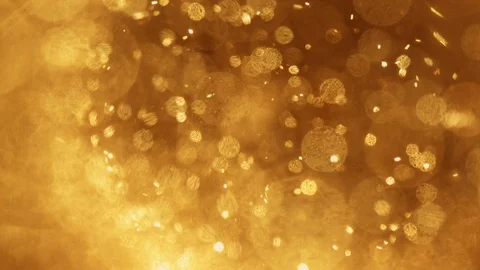 Golden fire particles exploding in front of dark background Stock Footage 120092883
