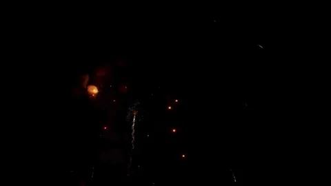 Golden firework trails float in the dark night sky Stock Footage 329673836