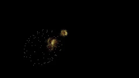 Golden fireworks explode brilliantly in the dark night sky Stock Footage 329673746