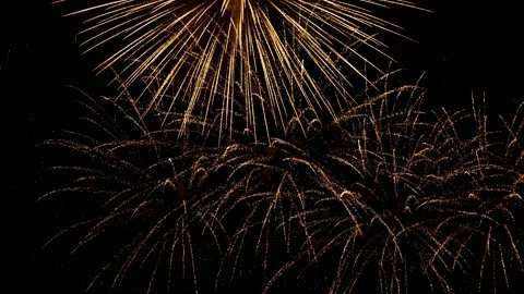 Golden fireworks explode with twinkling sparks in the black night sky, slow-mo 스톡 동영상 202287242