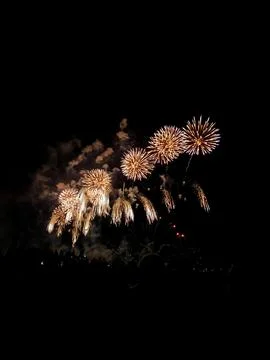 Golden fireworks exploding in night sky at Cannes 22 July 库存照片