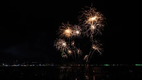 Golden Fireworks Exploding Over Ocean Beach Crowd In Pattaya Night Shot Stock Photos