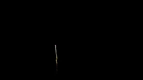 Golden fireworks trail and explode in the night sky 動画素材 329674126