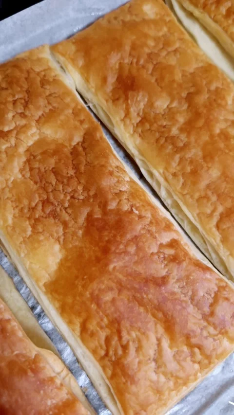 Golden Flaky Puff Pastry Sheets Cooling on Baking Tray Stock Footage 325222989