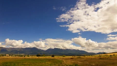 Golden fluffy clouds moving softly on the sky and the sun shining Stock Footage 280330501