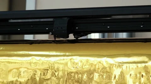 Golden foil cutting plotter machine. Vinyl cutter plotter machine and moving cut Stock Footage 146033070