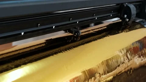 Golden foil cutting plotter machine. Vinyl cutter plotter machine and moving cut Stock Footage 146033155