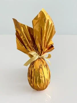 Golden Foil-Wrapped Easter Egg with Satin Bow Stock Photos